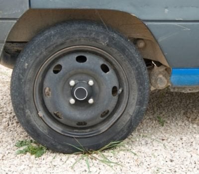 Car wheel on a gravel driveway