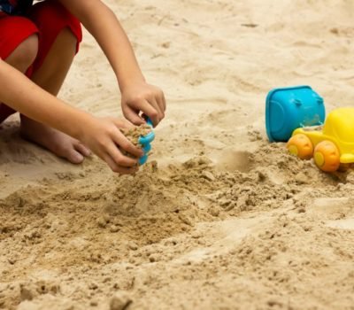 Child playing in sand pit