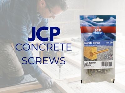Man drilling into wooden beams on a concrete floor in the background. Bag of JCP branded screws in the foreground, and blue lettering.