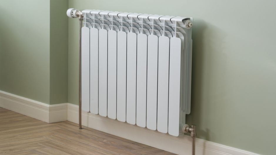 Central Heating Radiator on a sage green wall