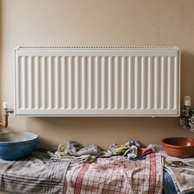 Cloths and bowls under radiator being prepared for bleeding