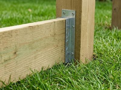 timber board installed using a u shaped galvanised bracket onto a fence post