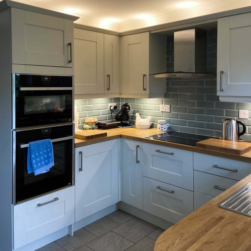 Double-NEFF-ovens-and-appliances-in-well-lit-shaker-kitchen-in-Spalding-intro image