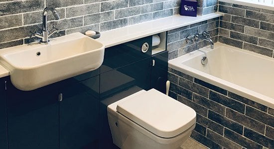 Black gloss and grey bricks for this small bathroom