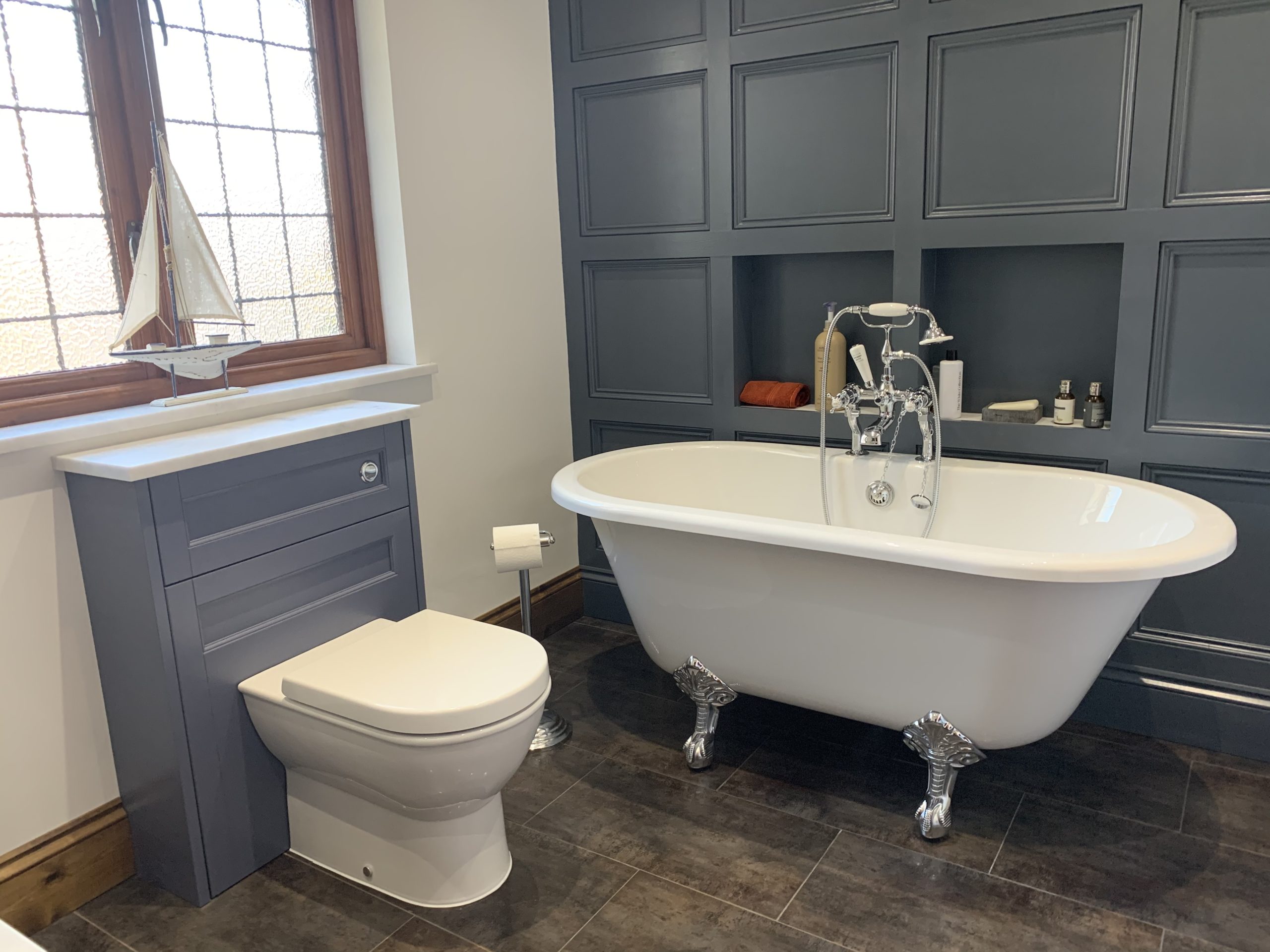 Bathroom Ideas - dark blue panelling behind this statement freestanding bath