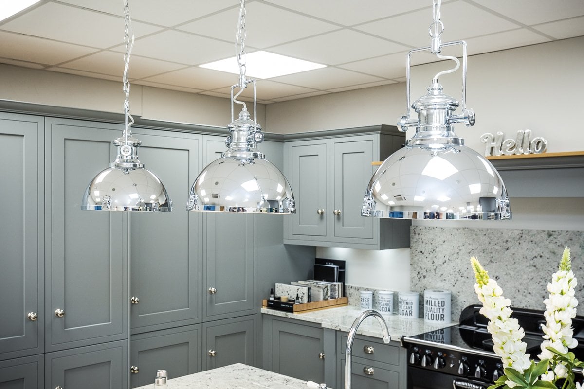 Grey Kitchen with chrome pendant lighting over a kitchen island