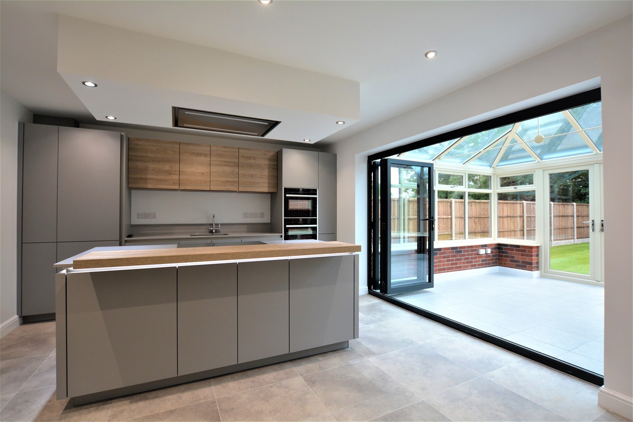 Grey Kitchen with wood breakfast bar feature