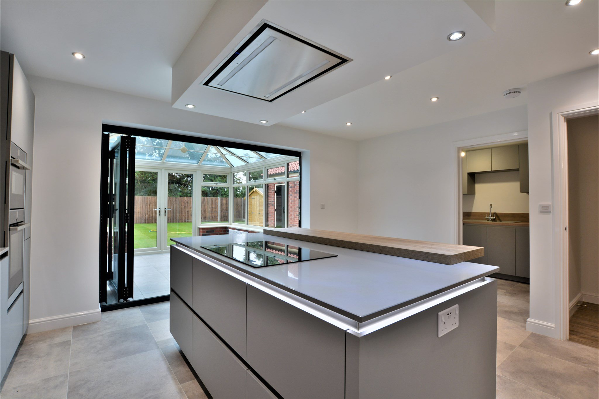 Slate look solid surface worktop with natural wood breakfast bar