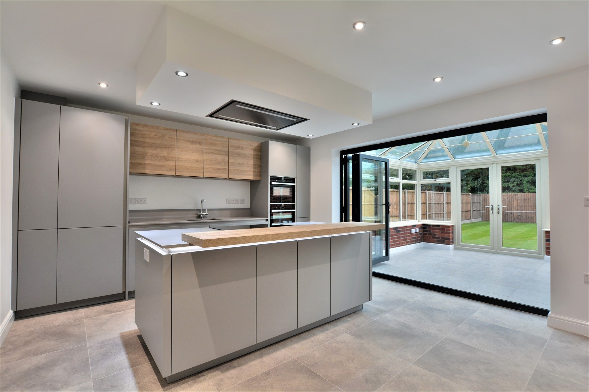 Grey kitchen with cantelevered breakfast bar on the kitchen Island - chanceoptions homes