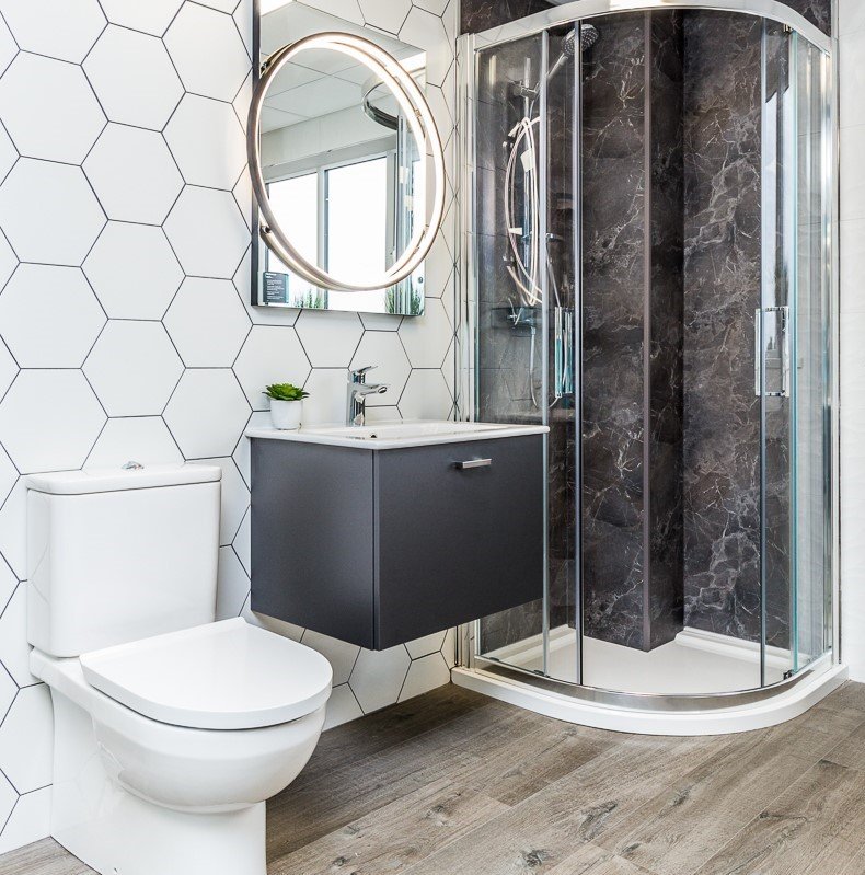 Hexagonal Tiles with modern grey shower panel and vanity unit