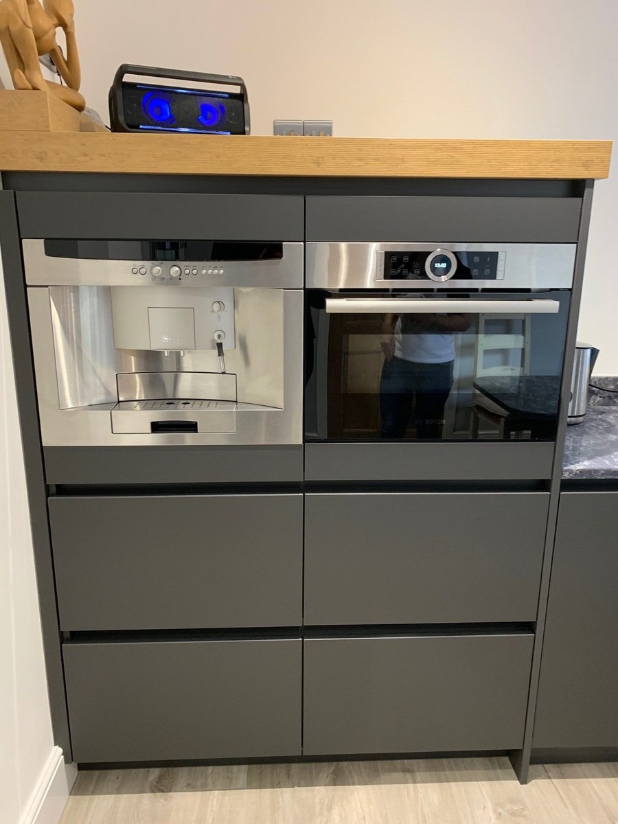 Neff oven and built-in appliance in Rotpunkt German kitchen