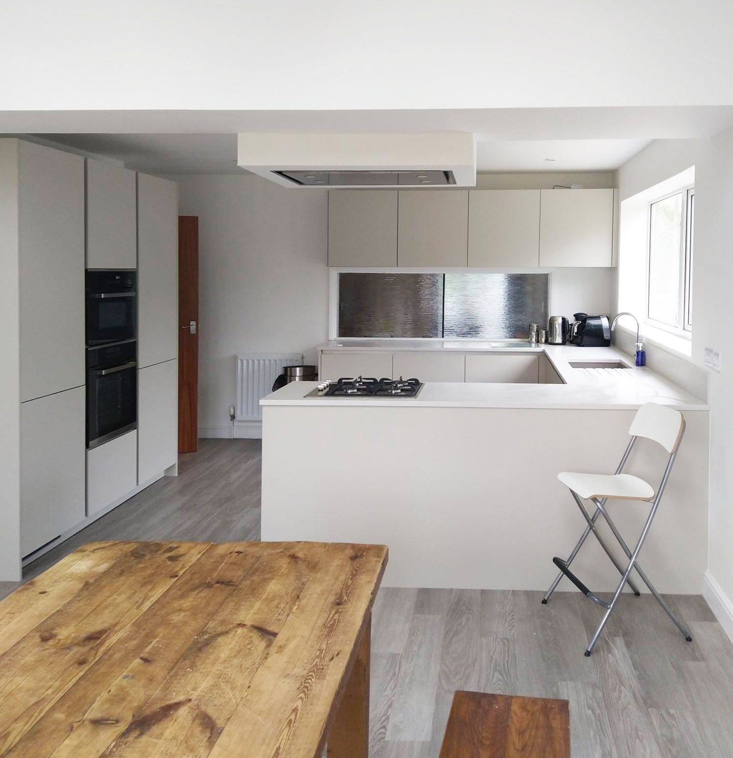 White kitchen with steel splashback