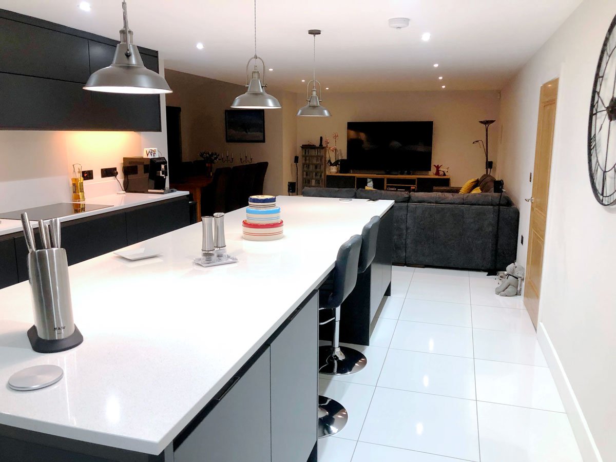 black kitchen island with contrasting white worktops