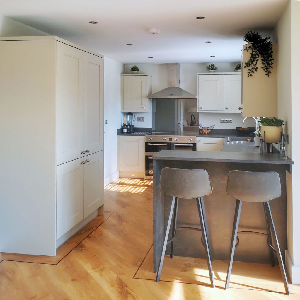 Grey Symphony Kitchen with painted shaker cabinets and mini breakfast bar