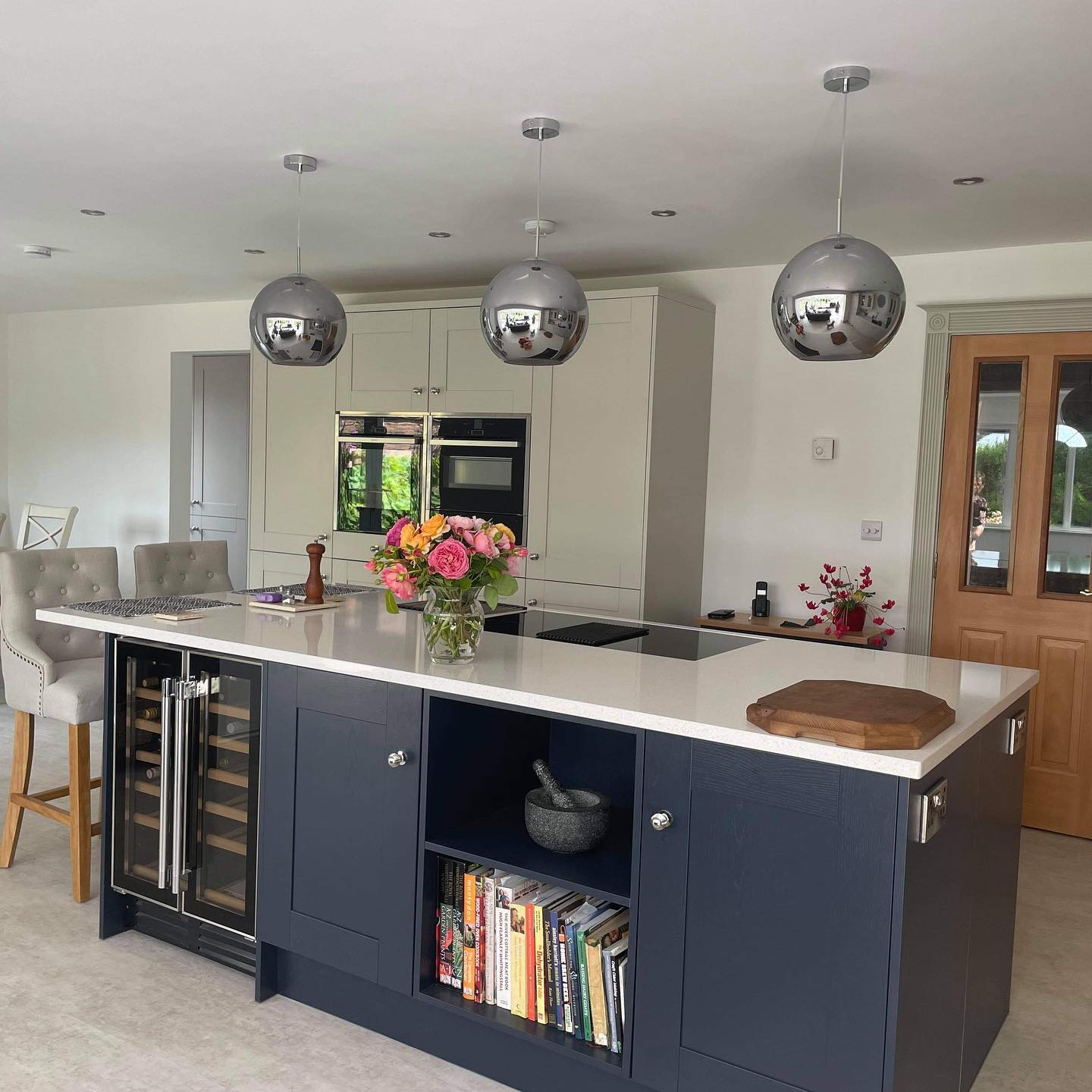 Blue Kitchen Island with Pendant Lighting and integrated Wine cooler