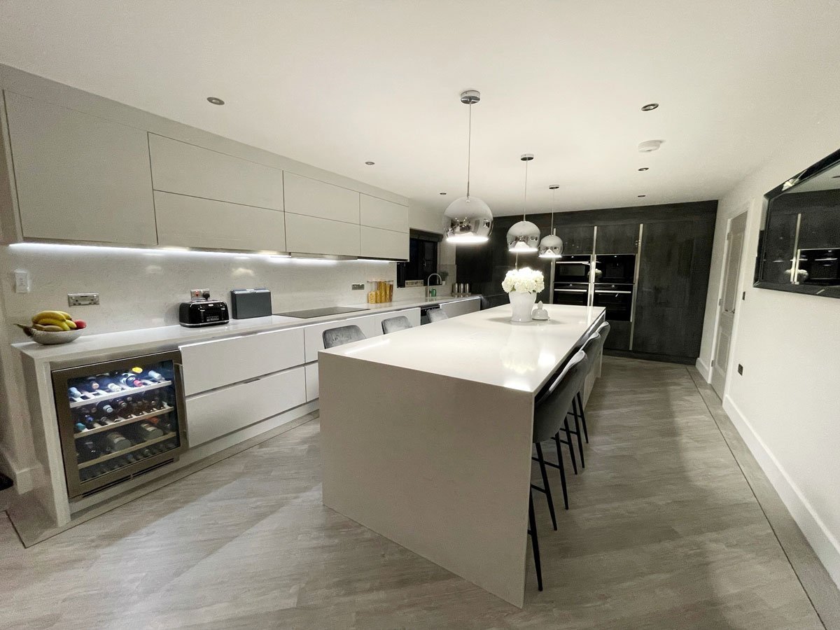 Open plan kitchen in white chrome and grey