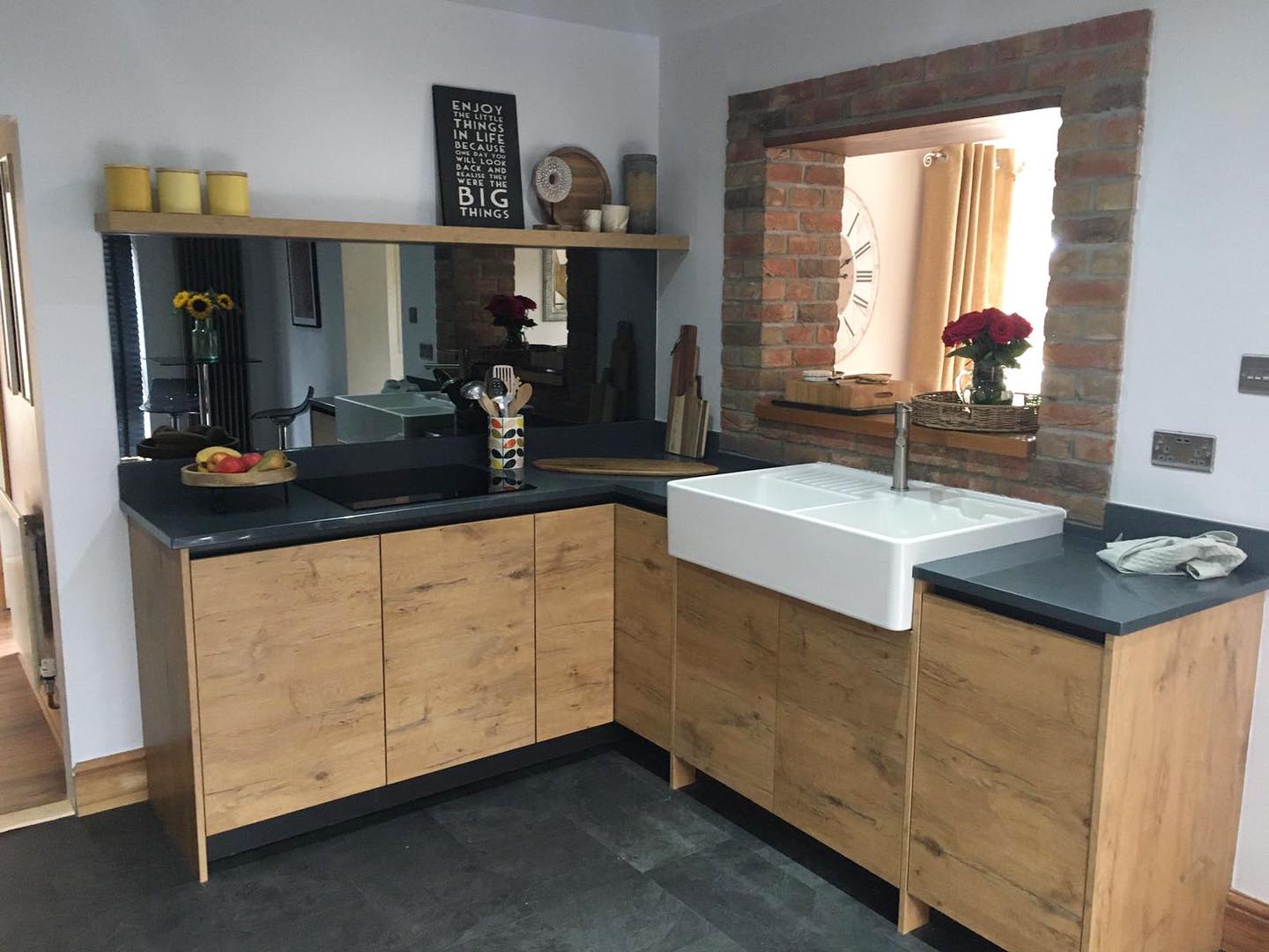 Oak kitchen with belfast sink and brick surround