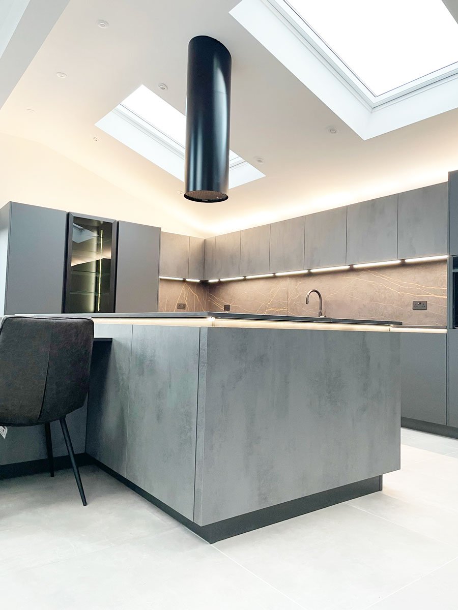 Grey fitted kitchen with black extractor hood