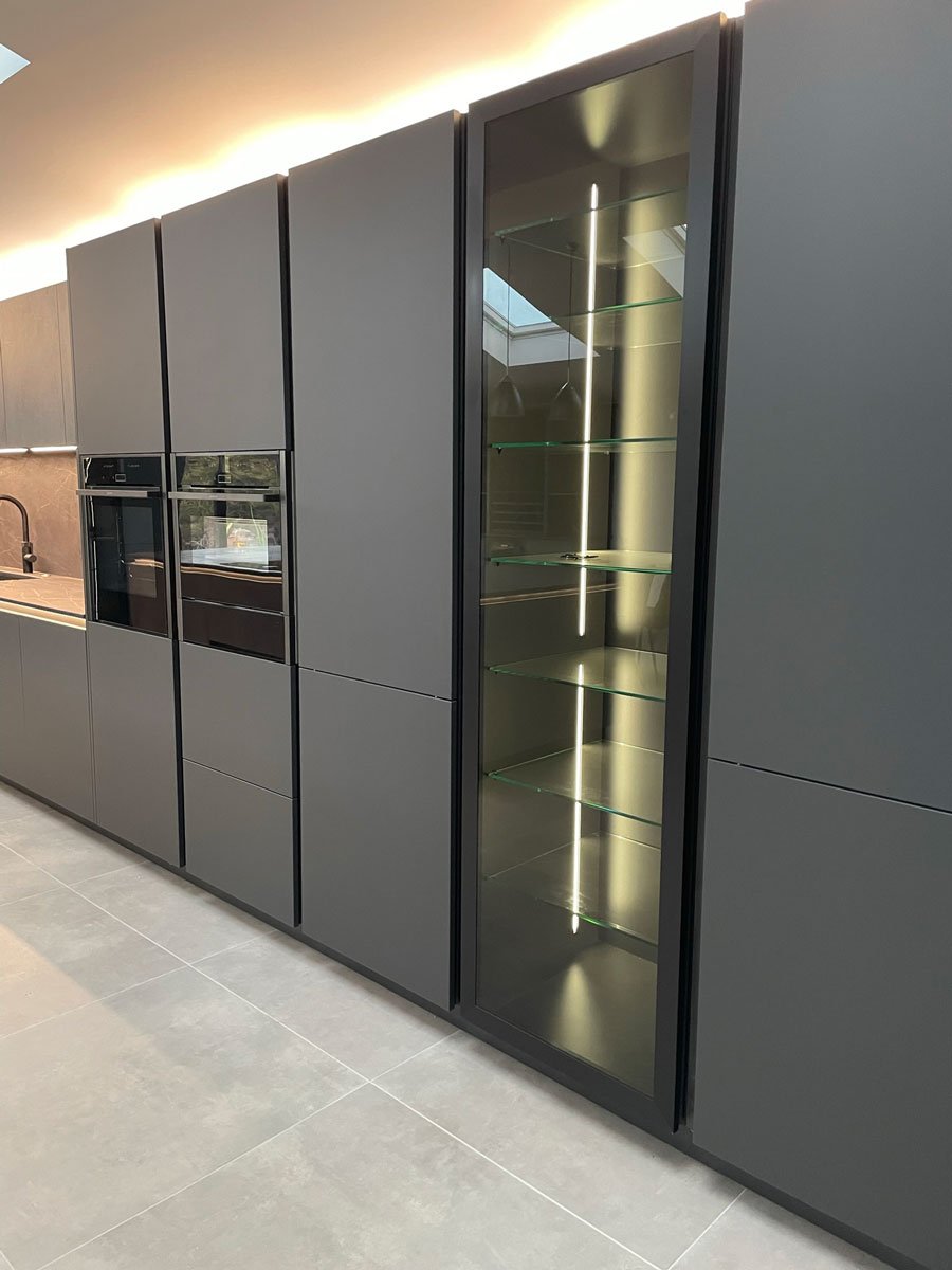 Rotpunkt handleless grey kitchen with glass fronted cabinets