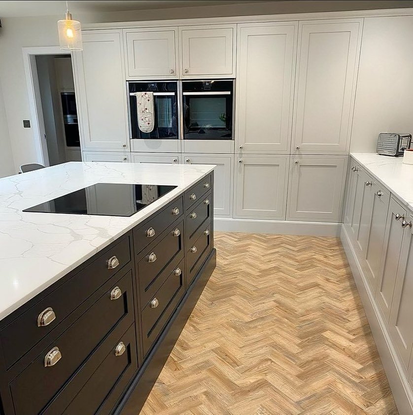 Two tone kitchen with white and blue shaker cabinets in a modern farmhouse style