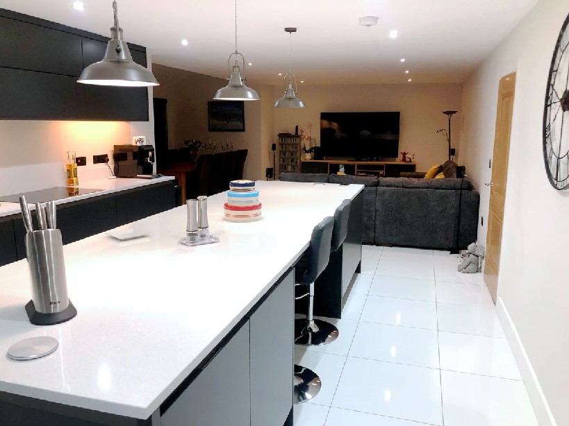 black kitchen island with contrasting white worktops