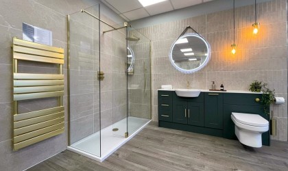 Bronze accents and lighting play a significant role in this bathroom.